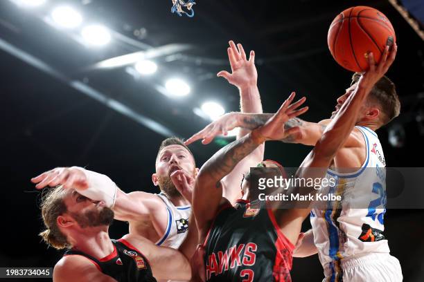Samson Froling of the Hawks is bumped in the face by Aron Baynes of the Bullets as Justin Robinson of the Hawks lays up a shot under pressure from...