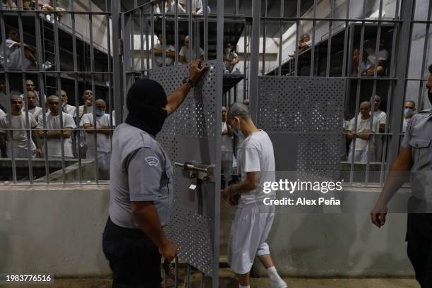 An inmate is led into a cell by officers at CECOT in Tecoluca on February 6, 2024 in San Vicente, El Salvador. On February of 2023 El Salvador...