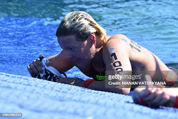 Netherlands' Sharon Van Rouwendaal catches her breath after winning the final of the women's 5km open water swimming event during the 2024 World...