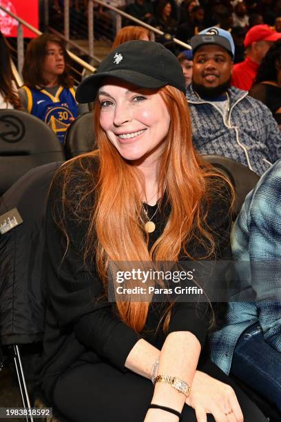 Actress Lindsay Lohan attends the game between Golden State Warriors and the Atlanta Hawks at State Farm Arena on February 03, 2024 in Atlanta,...