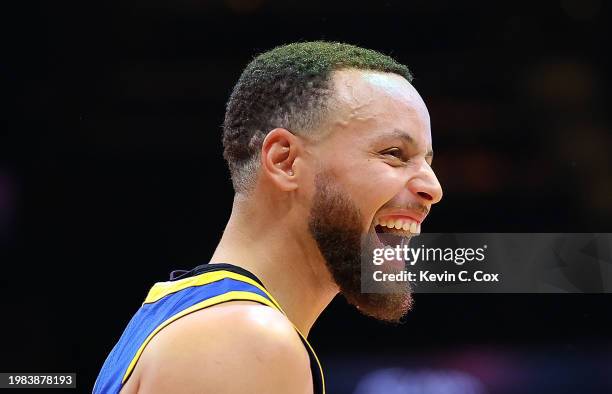 Stephen Curry of the Golden State Warriors reacts after Lester Quinones hit a three-point basket as time expired in the first quarter against the...