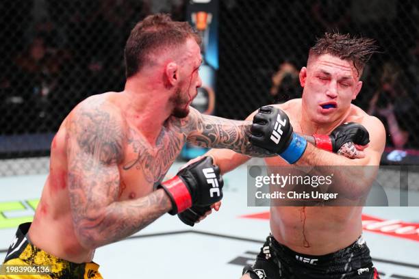 Renato Moicano of Brazil punches Drew Dober in a lightweight fight during the UFC Fight Night event at UFC APEX on February 03, 2024 in Las Vegas,...