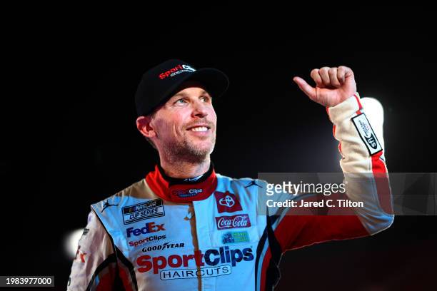Denny Hamlin, driver of the Sport Clips Haircuts Toyota, celebrates after winning the NASCAR Cup Series Busch Light Clash at The Coliseum at Los...