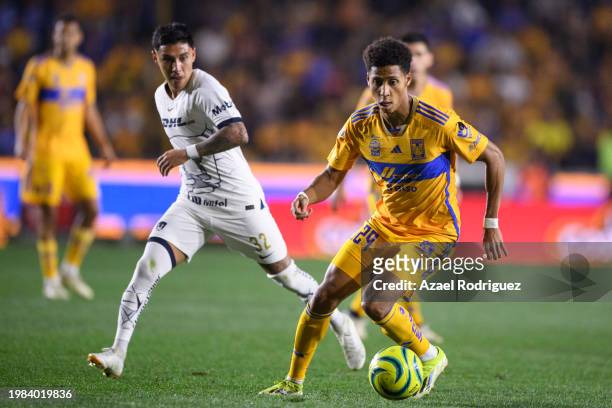 Jonathan Herrera of Tigres dribbles the ball while followed by Leonardo Suárez of Pumas during the 5th round match between Tigres UANL and Pumas UNAM...