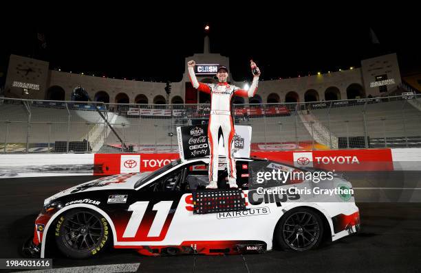 Denny Hamlin, driver of the Sport Clips Haircuts Toyota, celebrates in victory lane after winning the NASCAR Cup Series Busch Light Clash at The...