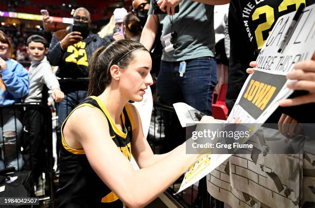 Caitlin Clark of the Iowa Hawkeyes signs autographs after the game against the Maryland Terrapins at Xfinity Center on February 03, 2024 in College...