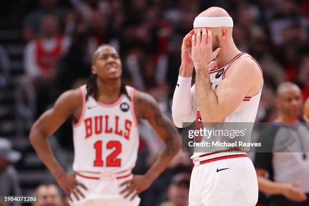 Alex Caruso and Ayo Dosunmu of the Chicago Bulls reacts against the Sacramento Kings during the second half at the United Center on February 03, 2024...