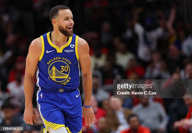 Stephen Curry of the Golden State Warriors reacts after hitting a three-point basket against the Atlanta Hawks during the fourth quarter at State...