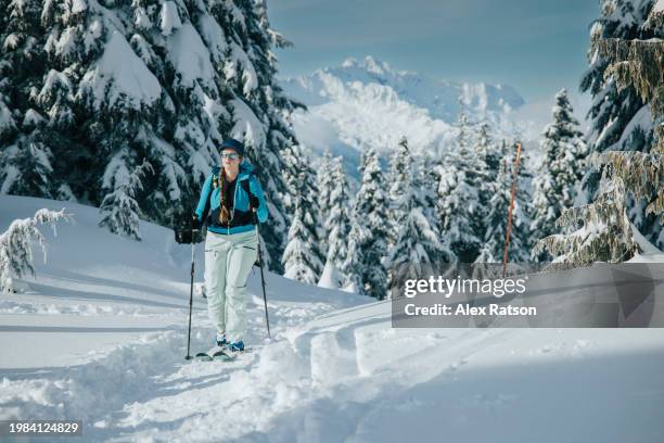 a backcountry skier with a dramatic view behind them near squamish, bc - nordic skiing event stock pictures, royalty-free photos & images