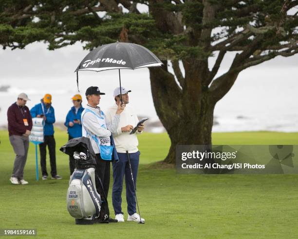 Scottie Scheffler of the United States preparing for an approach shot 18; during the third round of the 2024 AT&T Pebble Beach Pro-Am at Pebble Beach...