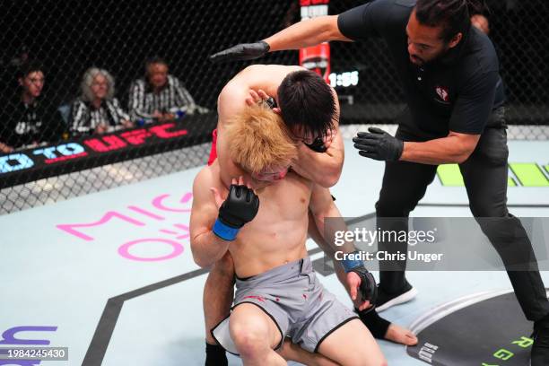 Rongzhu of China secures a rear choke submission against Shin Haraguchi of Japan in a lightweight fight during the Road to UFC Finals at UFC APEX on...