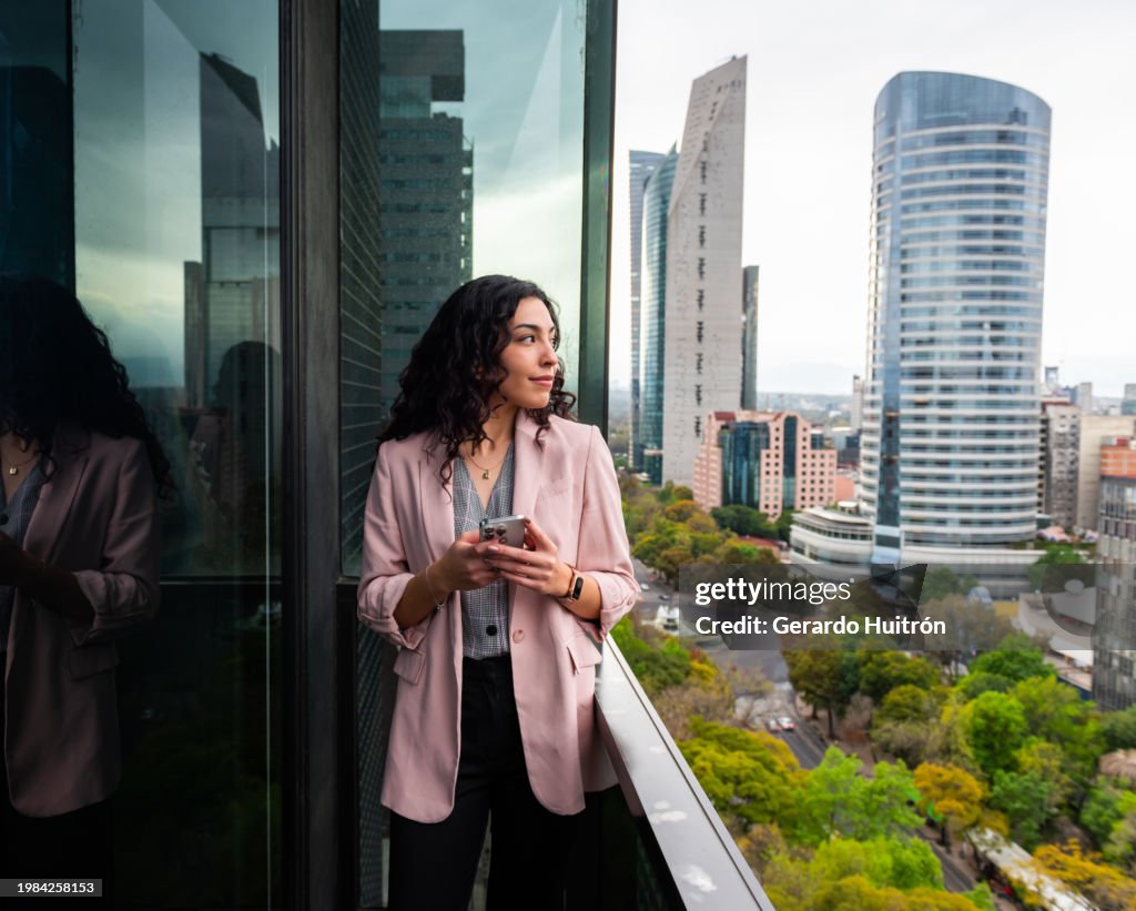 Business woman using cellphone in Mexico City