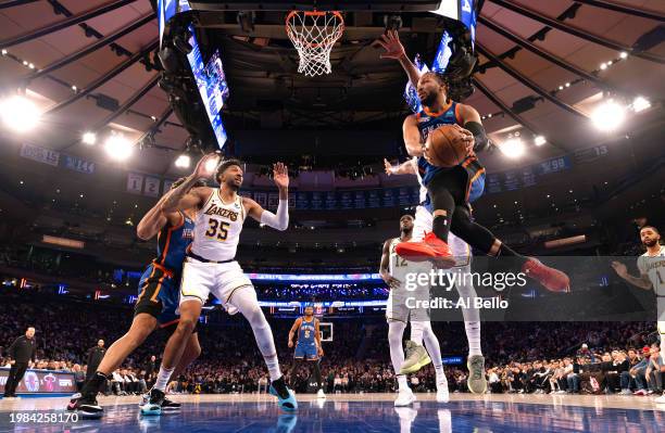 Jalen Brunson of the New York Knicks passes the ball against Christian Wood of the Los Angeles Lakers during their game at Madison Square Garden on...