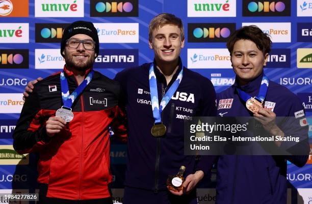 Silver medalist Laurent Dubreuil of Canada, gold medalist Jordan Stolz of the United States and bronze medalist Yuma Murakami of Japan pose with...