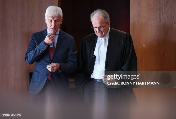 Former CEO of German carmaker Volkswagen Matthias Mueller and his authorised representative Eberhard Kempf leave the room during a break of the model...