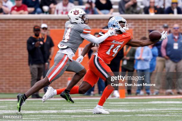 Wide Receiver Devontez Walker of North Carolina from the National Team makes a one-handed catch across the middle over Cornerback DJ James of Auburn...
