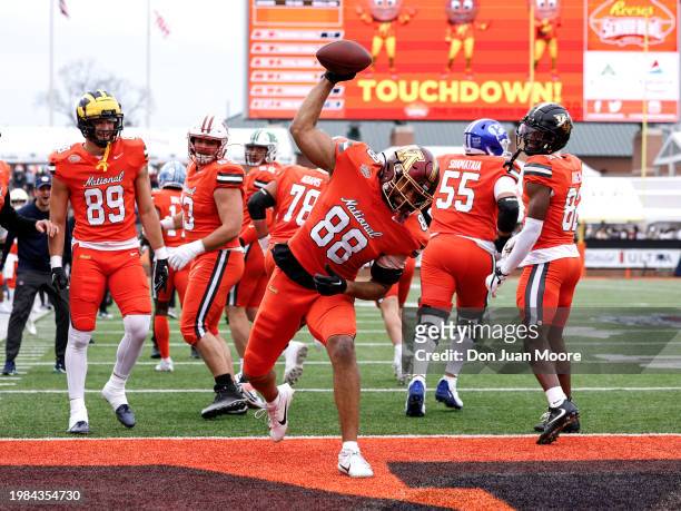 Tight End Brevyn Spann-Ford of Minnesota from the National Team spike the ball in the endzone after scoring a touchdown during the 2024 Reese's...