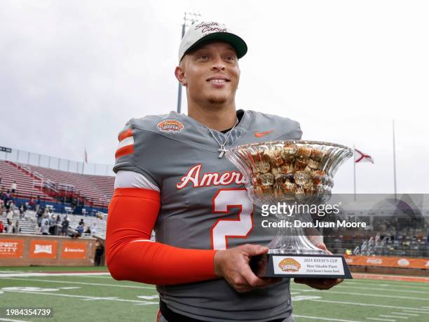 Quarterback Spencer Rattler of South Carolina from the American Team poses with the MVP award on the field after the 2024 Reese's Senior Bowl at...