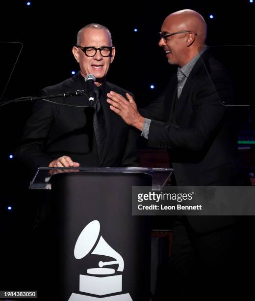 Tom Hanks and CEO of the Recording Academy Harvey Mason jr. Speak onstage during the Pre-GRAMMY Gala & GRAMMY Salute to Industry Icons Honoring Jon...