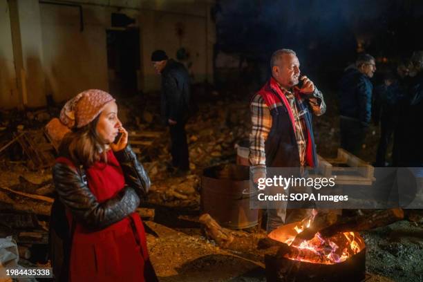 People wait by the fire to commemorate the anniversary, as they did in the early days of the earthquake. In Hatay, one of the provinces most affected...