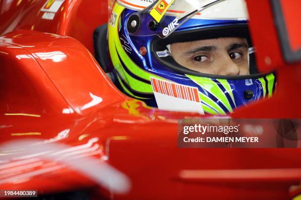 Ferrari Brazilian's driver Felipe Massa sits in his car in the pits of the Monza racetrack on September 13, 2008 near Milan, during the third...