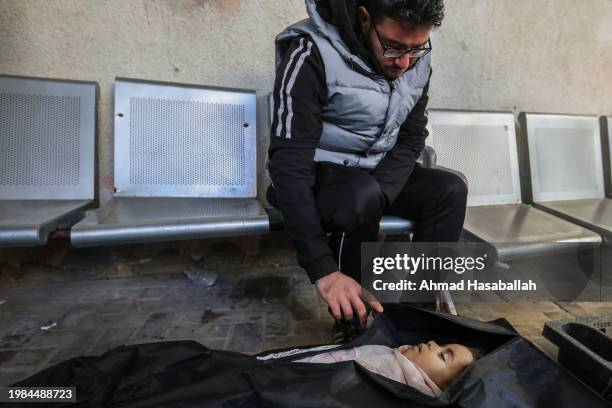 Man mourns besidethe body of a dead child, on February 4, 2024 in Rafah, Gaza. Gaza's health ministry reported that more than 27,000 people had been...