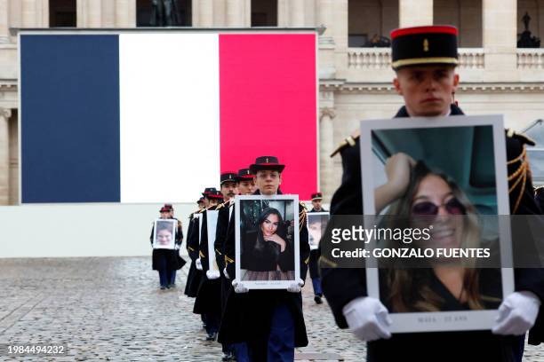 French Republican Guards walk with the portraits of the 42 French and French-Israeli citizens killed in the Hamas attacks, during a tribute ceremony...