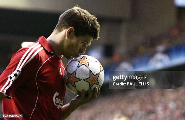 Liverpool's English midfielder Steven Gerrard kisses the ball as he prepares to take a corner kick against Chelsea during their UEFA Champions League...