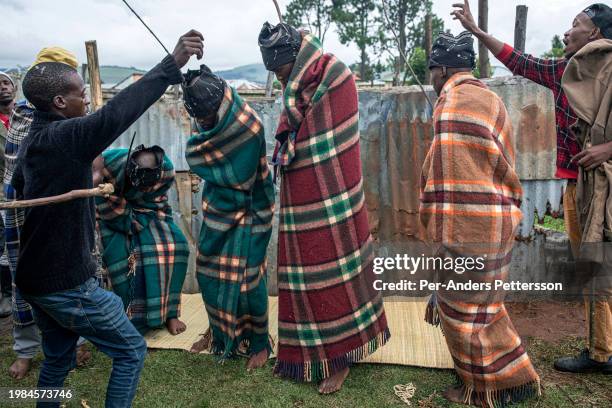 Men dance and sing to welcome back Xhosa boys who have returned from their manhood ceremony on December 24 in Hopedale in Eastern Cape Province,...