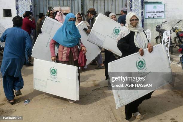 Election presiding officers leave after collecting voting materials at a distribution center in Karachi on February 7 a day prior Pakistan's national...