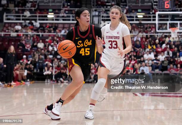 Kayla Padilla of the USC Trojans dribbles the ball up court pass Hannah Jump of the Stanford Cardinal during the first quarter of an NCAA basketball...