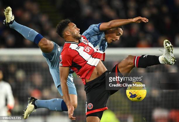 Auston Trusty of Sheffield United jumps for the ball with Youri Tielemans of Aston Villa during the Premier League match between Sheffield United and...