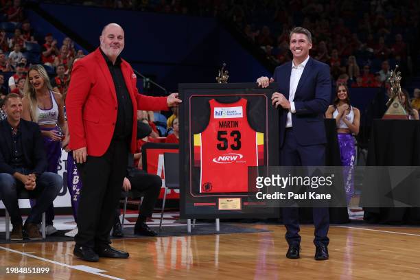 Craig Hutchison presents former Wildcats player and captain Damian Martina framed jersey during his jersey retirement ceremony following the round 18...