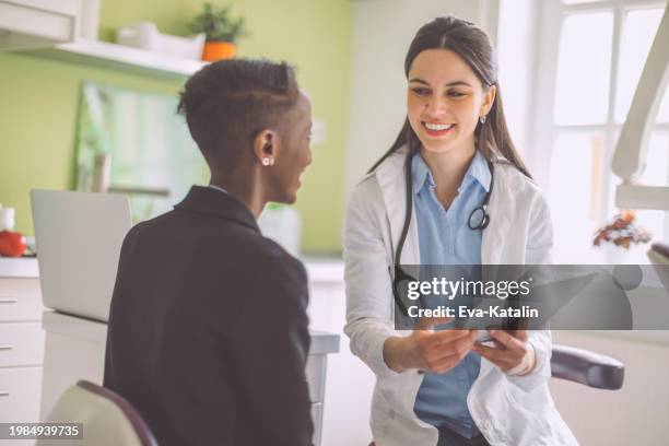 doctor consulting her patient - referral stock pictures, royalty-free photos & images