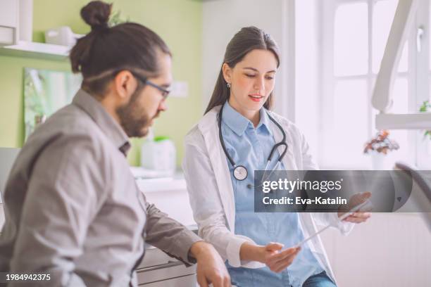 doctor consulting her patient - health insurance portability and accountability act stock pictures, royalty-free photos & images