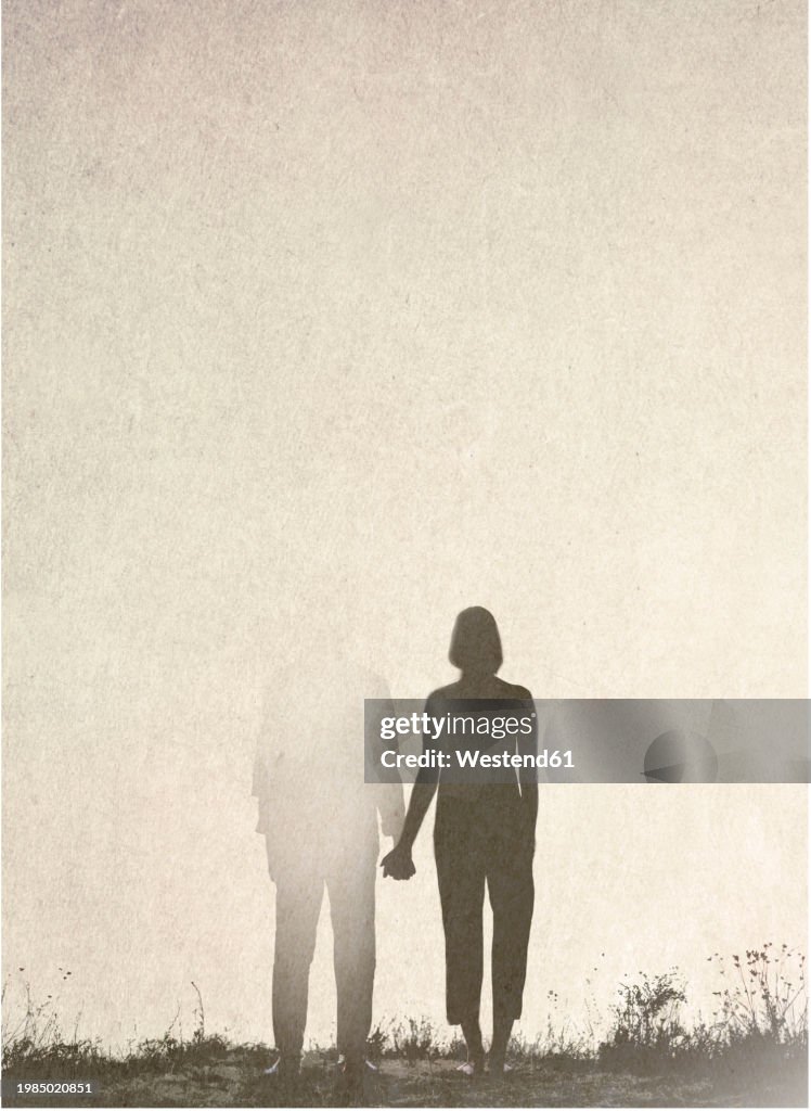 Woman holding hands with fading man in relationship