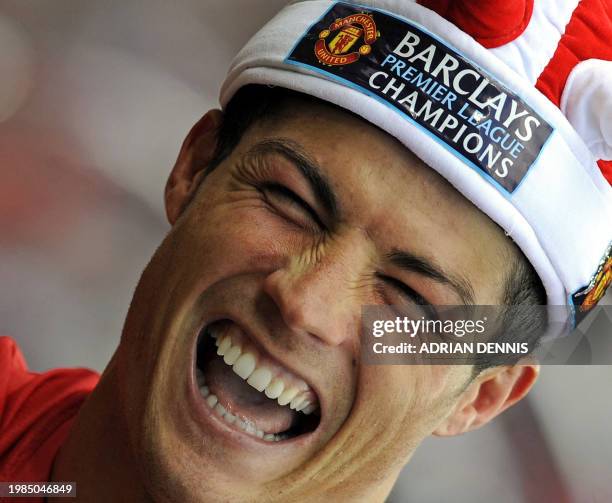 Manchester United's Portuguese midfielder Cristiano Ronaldo celebrates after they clinch the title with a 0-0 draw against Arsenal in the English...