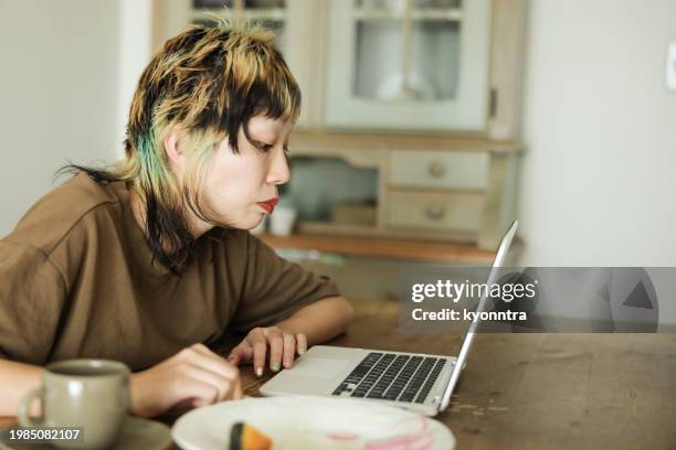 young woman using laptop indoors - fashion show at home stock pictures, royalty-free photos & images