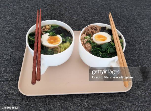 asian ramen soba noodle soup close up with chicken, boiled egg, nori, green spinich and green onion served with chopsticks - miso sauce stock pictures, royalty-free photos & images
