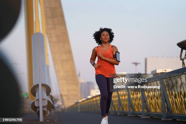 motion of young woman jogging exercise in the morning on city street - corredora de footing fotografías e imágenes de stock