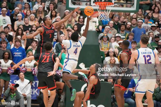Isaiah Stevens of the Colorado State Rams drives to the basket under Micah Parrish of the San Diego State Aztecss during a college basketball game at...