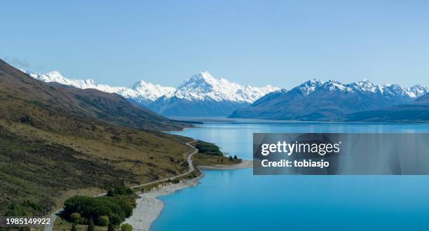 scenic south island country road leading to mount cook - mt cook stock pictures, royalty-free photos & images