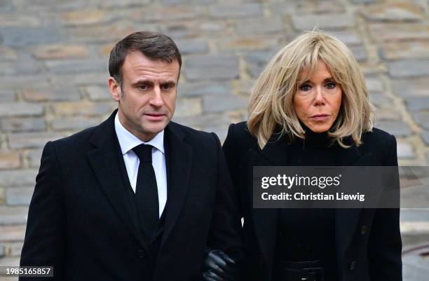 French President Emmanuel Macron and his wife Brigitte Macron leave after a ceremony to pay tribute to the French victims of the attack by Hamas...