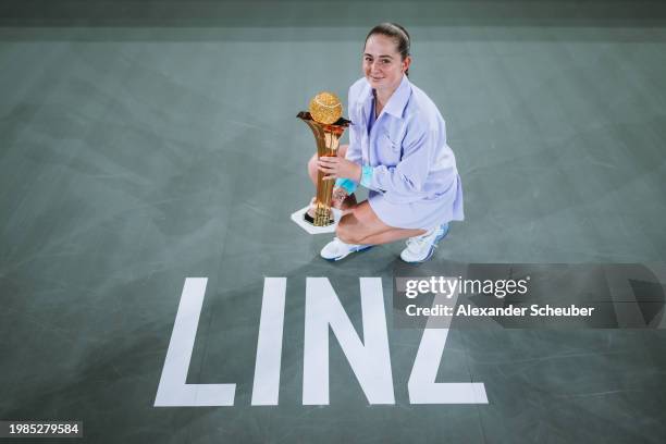 Jelena Ostapenko of Latvia celebrates winning with the Swarovski Trophy during day eight of the Upper Austria Ladies Linz 2024 on February 04, 2024...