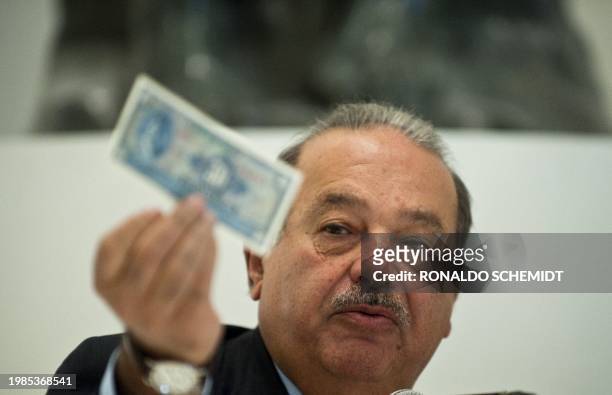 Mexican tycoon Carlos Slim speaks during a press conference at the Soumaya Museum in Mexico City, on the eve of its opening to the public, on March...