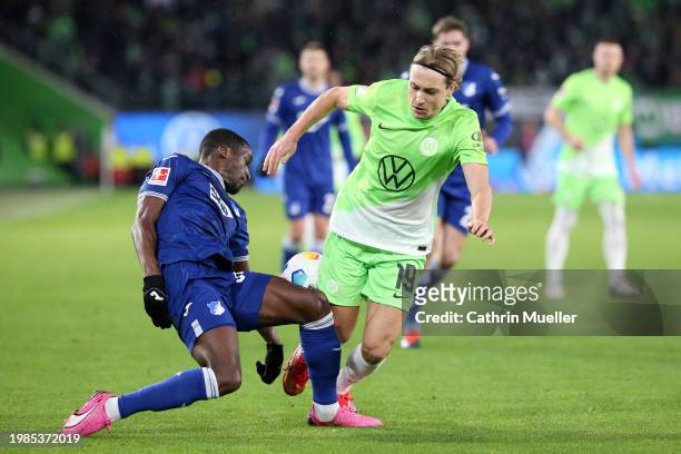 Lovro Majer of VfL Wolfsburg is challenged by Stanley Nsoki of TSG 1899 Hoffenheim during the Bundesliga match between VfL Wolfsburg and TSG...