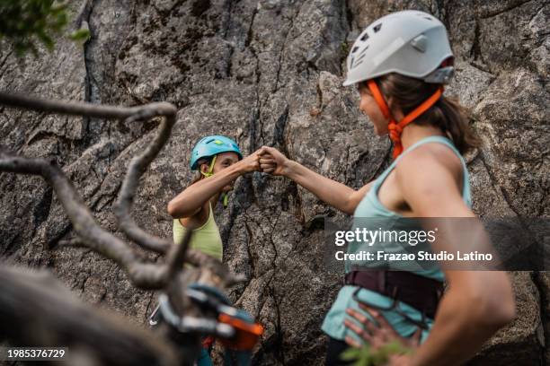 climber friends touch fists during a climbing - rock climbing stock pictures, royalty-free photos & images