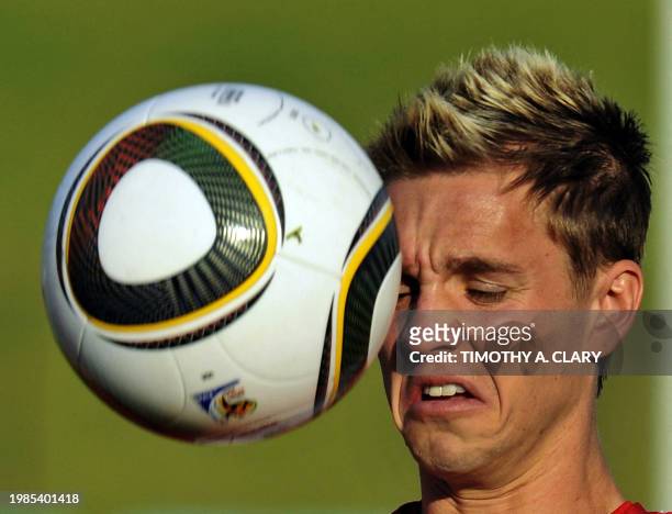 National football team midfielder Stuart Holden grimaces as he plays wit ha football during a training session at Pilditch stadium June 3, 2010 in...