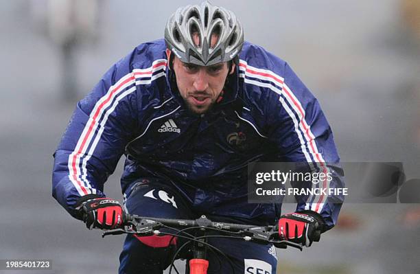 France's national football forward Franck Ribery rides bikes during a training session with team mates, on June 1, 2010 in Bourg-Murat, on the French...