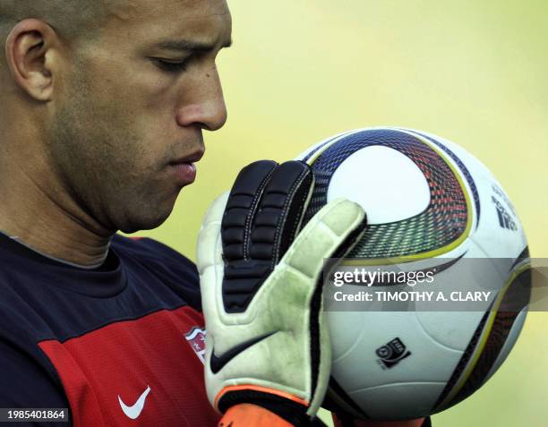 National football team goalkeeper Tim Howard looks at football during a training session at Pilditch stadium June 3, 2010 in preparation for the 2010...